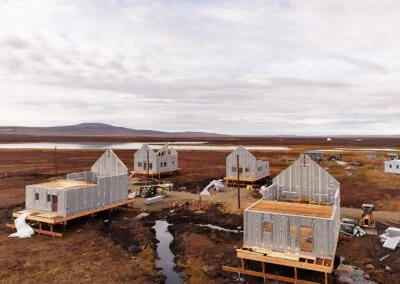 AirLight panelized cabin cluster mid-construction on remote prairie