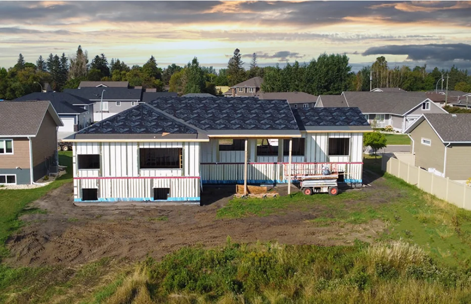 Long single-story residence with AirLight panel walls at dusk